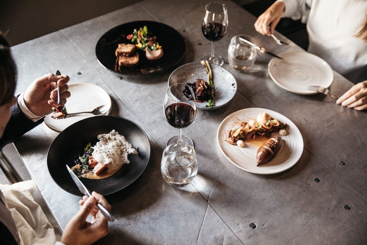 Plates and red wine on a restaurant table
