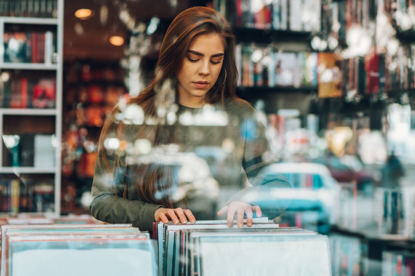 A woman flips through vinyl in a record store