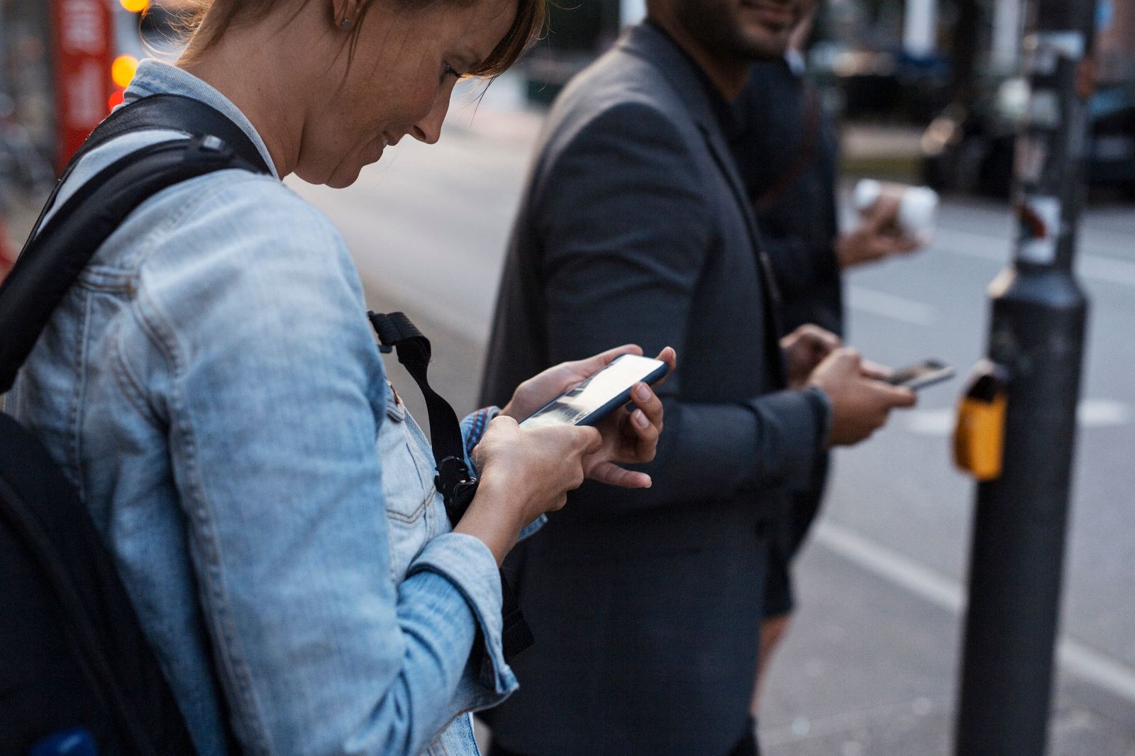 People on a city street looking at their phones